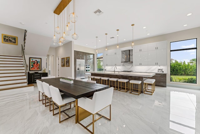 dining room featuring a notable chandelier, sink, and plenty of natural light