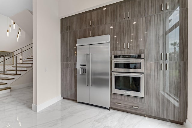 kitchen featuring appliances with stainless steel finishes and dark brown cabinetry