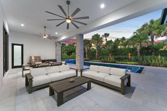 patio terrace at dusk with area for grilling, ceiling fan, a fenced in pool, and outdoor lounge area