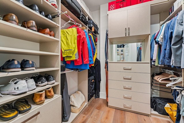 walk in closet featuring light hardwood / wood-style flooring