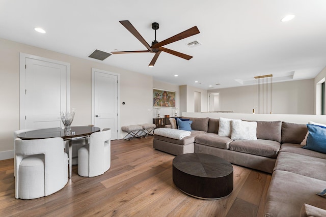 living room with hardwood / wood-style flooring and ceiling fan