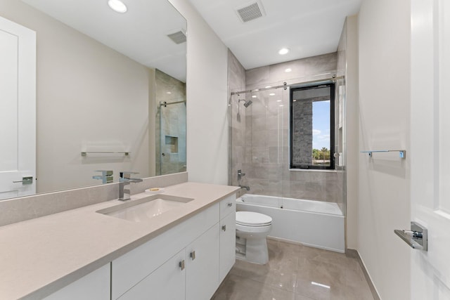 full bathroom featuring vanity, toilet, and bath / shower combo with glass door