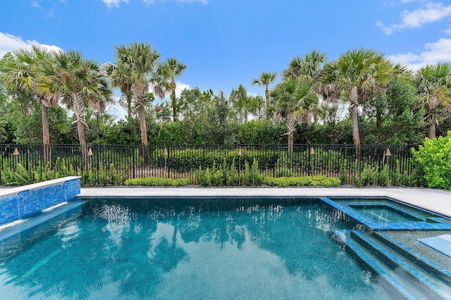 view of pool with an in ground hot tub