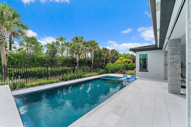 view of swimming pool with an in ground hot tub and a patio area