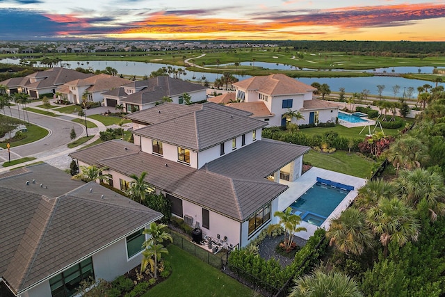 aerial view at dusk with a water view