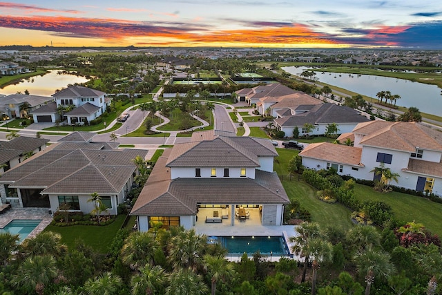 aerial view at dusk with a water view