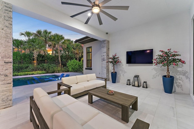 patio terrace at dusk with ceiling fan, a fenced in pool, and an outdoor hangout area