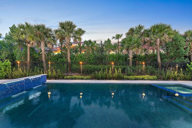 pool at dusk with pool water feature