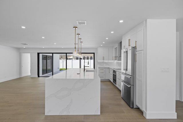 kitchen featuring stainless steel appliances, recessed lighting, light wood-style floors, and white cabinetry