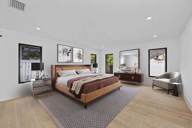 bedroom with light wood-type flooring, baseboards, visible vents, and recessed lighting