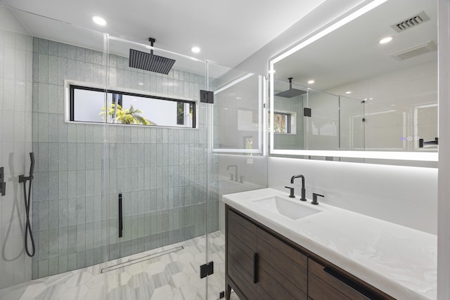 full bath featuring vanity, visible vents, and a shower stall