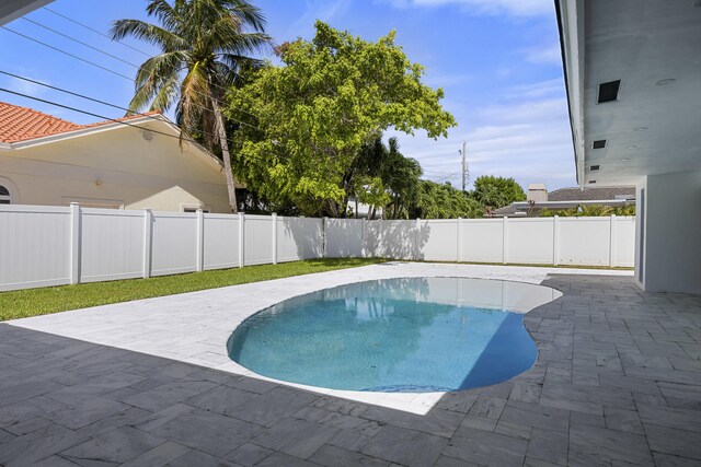 view of swimming pool with a fenced backyard, a patio, and a fenced in pool