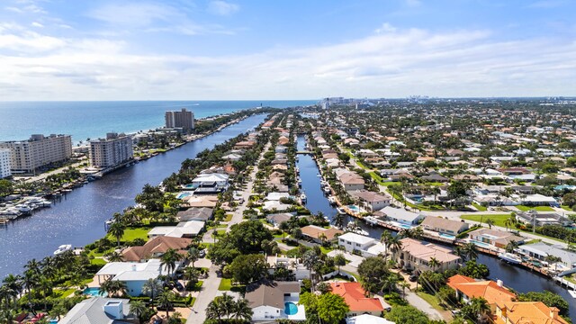drone / aerial view featuring a residential view and a water view