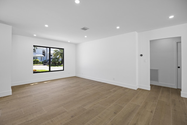 spare room featuring recessed lighting and visible vents