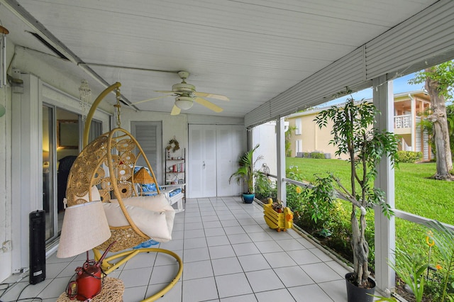 sunroom featuring a ceiling fan