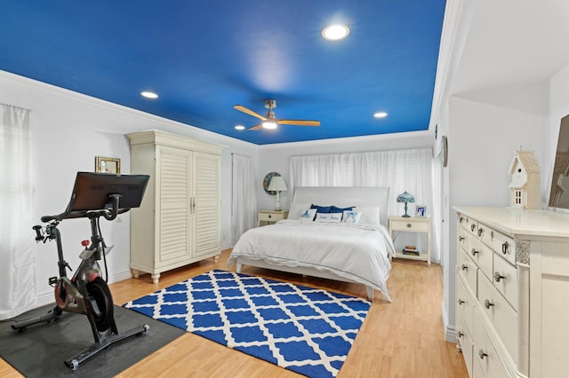 bedroom featuring ornamental molding, ceiling fan, and light hardwood / wood-style flooring