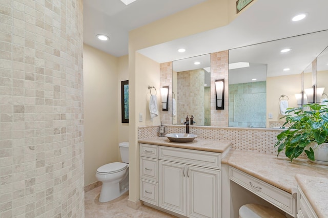 bathroom with walk in shower, backsplash, vanity, and toilet