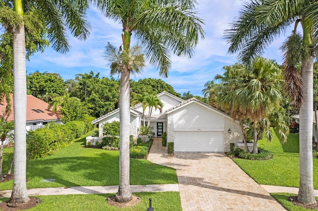 view of front of house with a front lawn and a garage