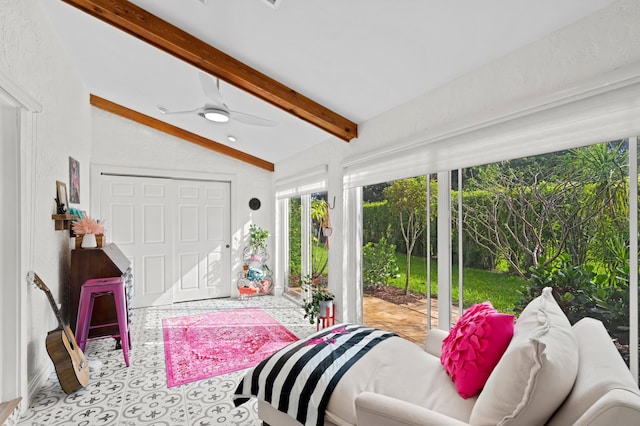 sunroom / solarium with ceiling fan and vaulted ceiling with beams