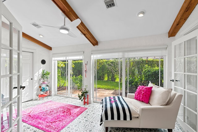 sunroom / solarium featuring beam ceiling, ceiling fan, and a healthy amount of sunlight