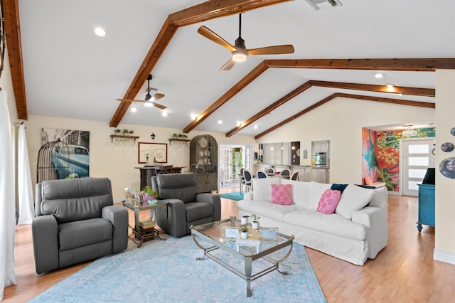 living room with ceiling fan, light hardwood / wood-style flooring, and lofted ceiling with beams