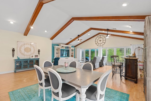 dining area featuring ceiling fan, vaulted ceiling with beams, and light wood-type flooring