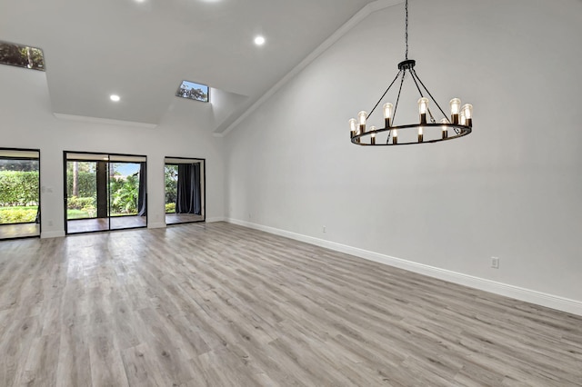 unfurnished room featuring light hardwood / wood-style floors and high vaulted ceiling