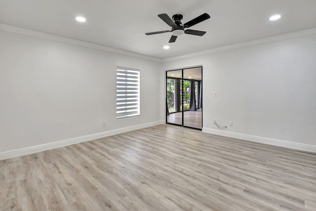 empty room featuring ceiling fan, light hardwood / wood-style floors, and ornamental molding