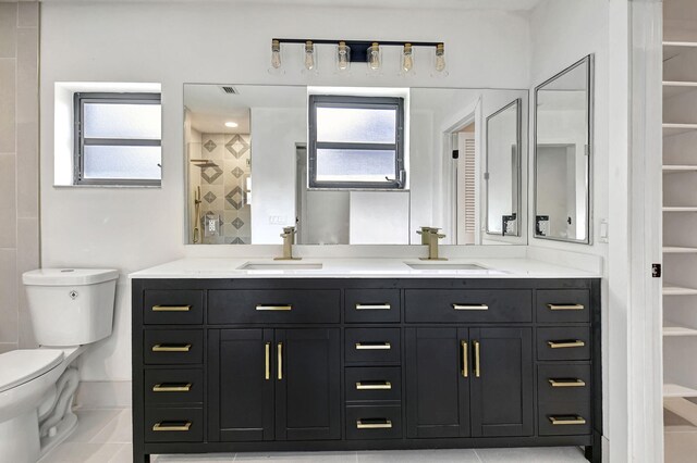 bathroom featuring tile patterned flooring, vanity, and toilet