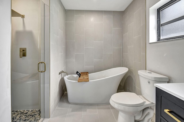 full bathroom with tile patterned flooring, toilet, vanity, independent shower and bath, and tile walls