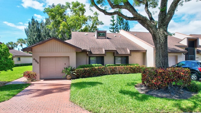 view of front of property featuring a garage and a front yard