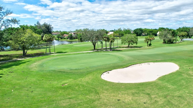 view of property's community with a lawn and a water view