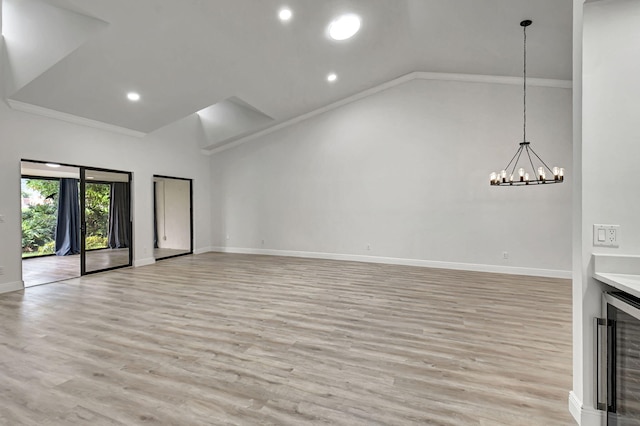 unfurnished living room featuring light hardwood / wood-style flooring, beverage cooler, and crown molding