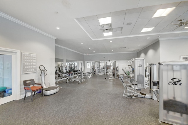 gym with ceiling fan, crown molding, a towering ceiling, and a drop ceiling