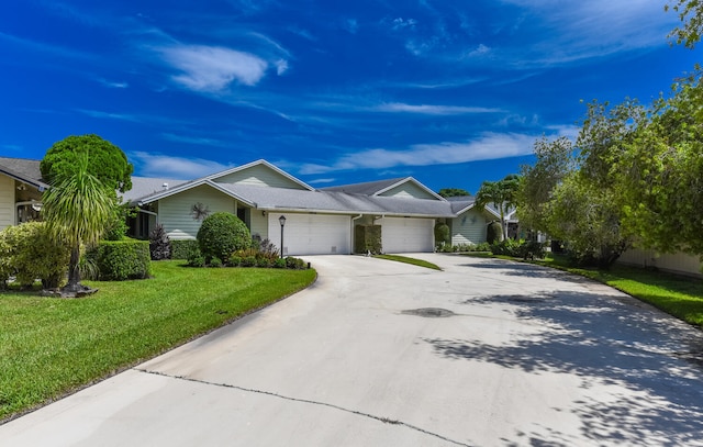 ranch-style house featuring a garage and a front yard