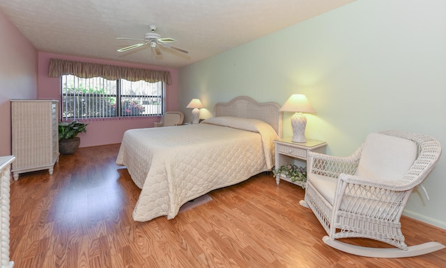 bedroom featuring ceiling fan and hardwood / wood-style flooring