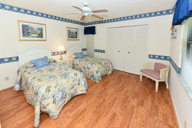 bedroom with hardwood / wood-style floors, ceiling fan, and a closet