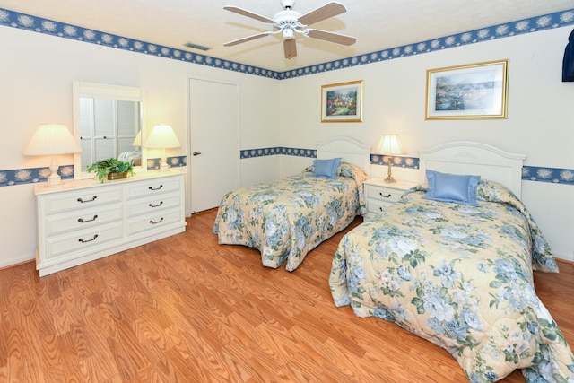 bedroom featuring light wood-type flooring and ceiling fan