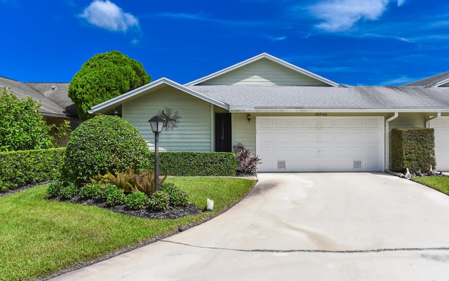 single story home with a front lawn and a garage