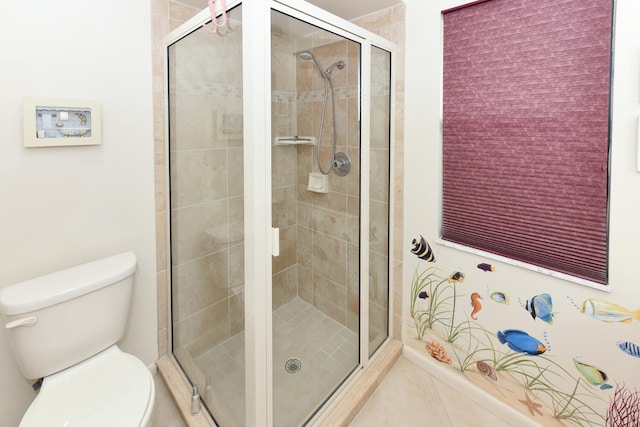 bathroom with a shower with door, toilet, and tile patterned floors