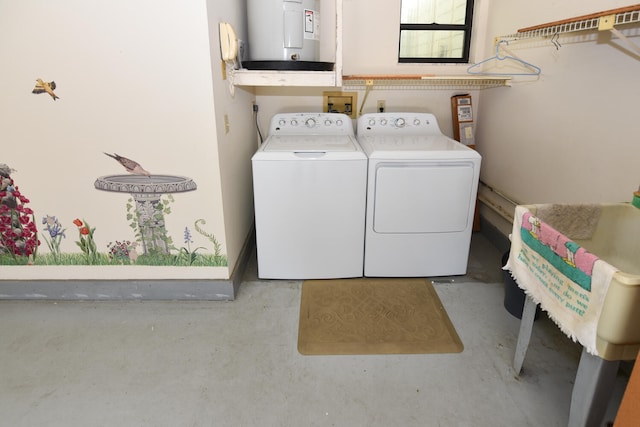 clothes washing area with electric water heater and washing machine and dryer