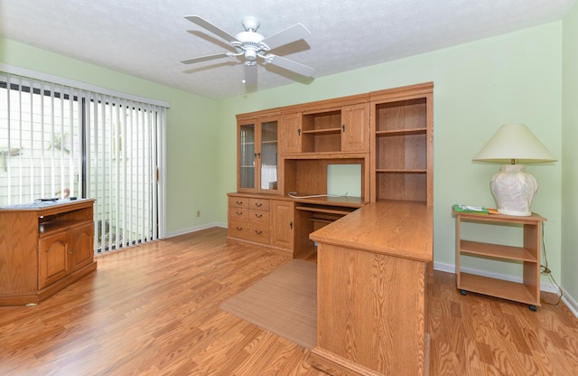 home office with ceiling fan, a textured ceiling, and light wood-type flooring