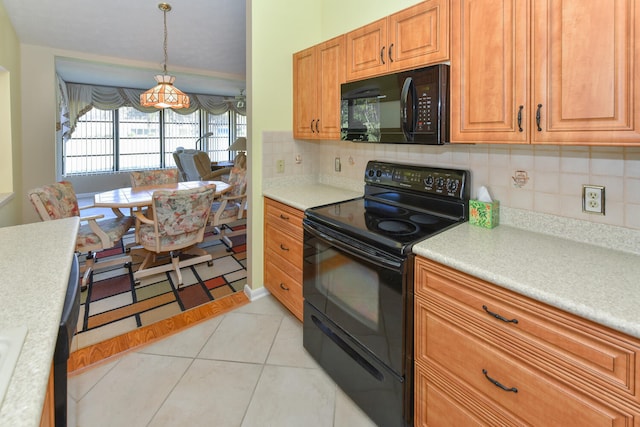 kitchen with decorative backsplash, black appliances, pendant lighting, and light tile patterned flooring