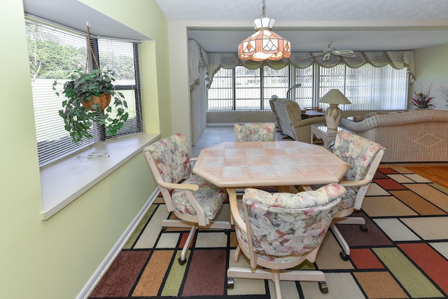 dining space featuring a wealth of natural light and a textured ceiling