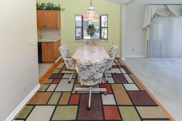 tiled dining room featuring lofted ceiling