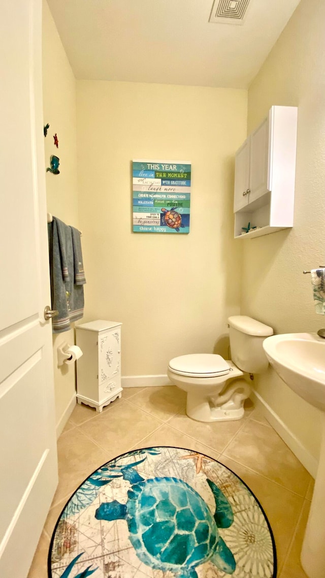 bathroom featuring tile patterned flooring and toilet