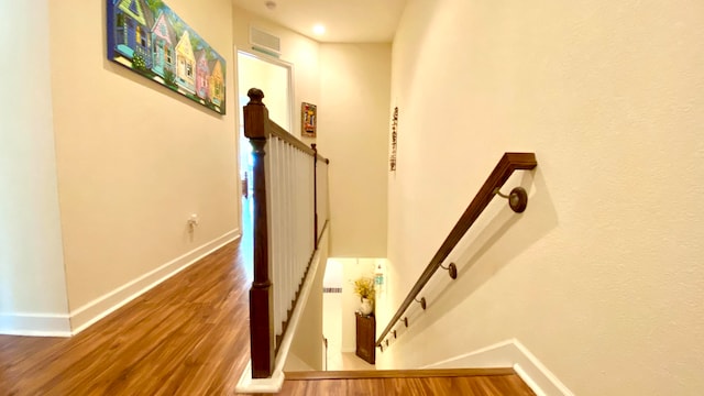 stairs with hardwood / wood-style floors