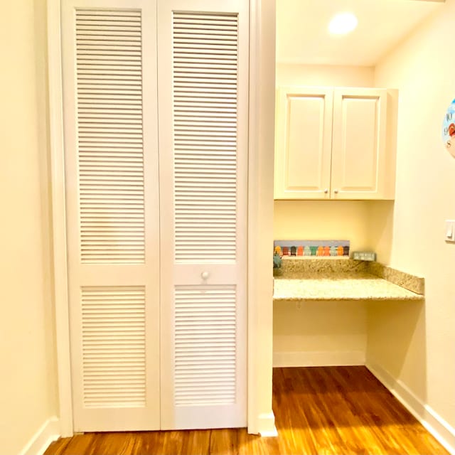 laundry room with hardwood / wood-style floors