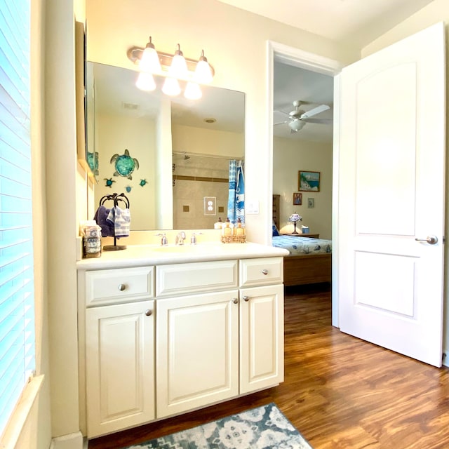 bathroom with hardwood / wood-style floors, vanity, and ceiling fan