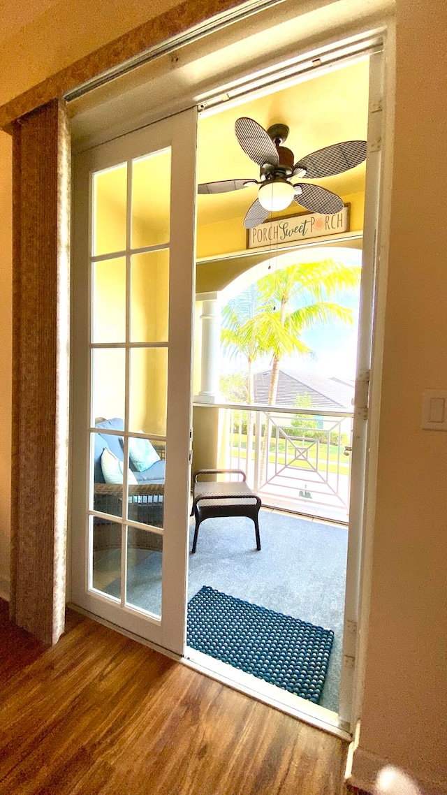 doorway featuring ceiling fan and wood-type flooring